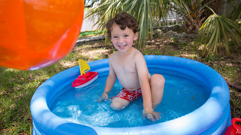 boy playing in a pool