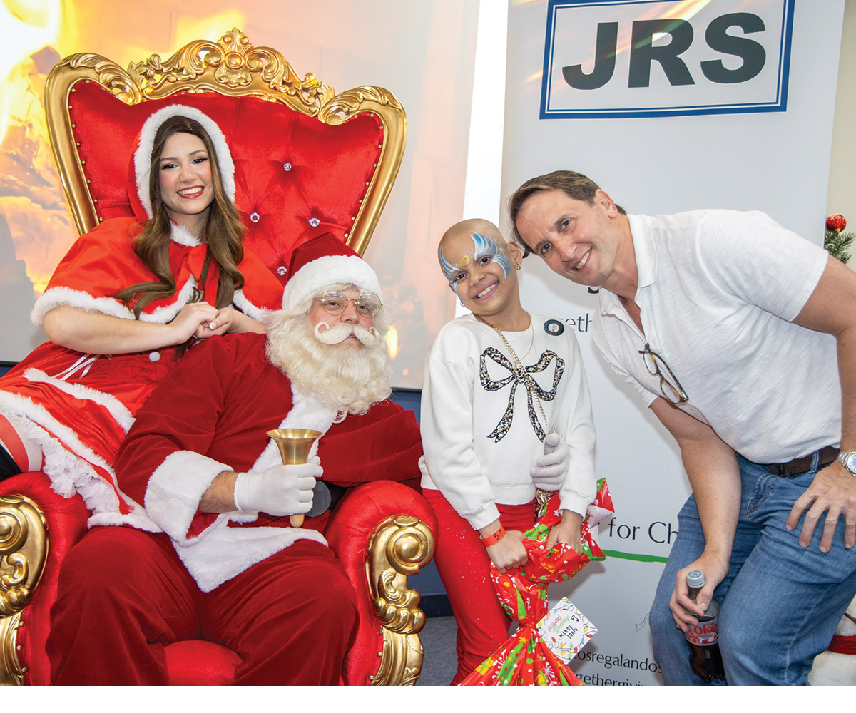 large family holding sporting gifts.