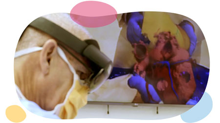 Dr. hannan wearing goggles while a rendering of a heart is projected.