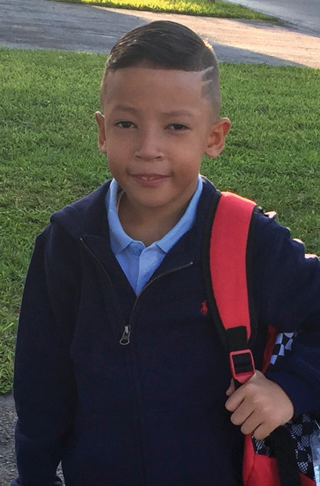 boy with 22q ready for school in his school uniform.