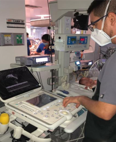 technician at echocardiography machine.
