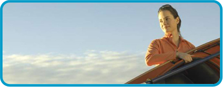 teenage girl with kayak against a background of clouds