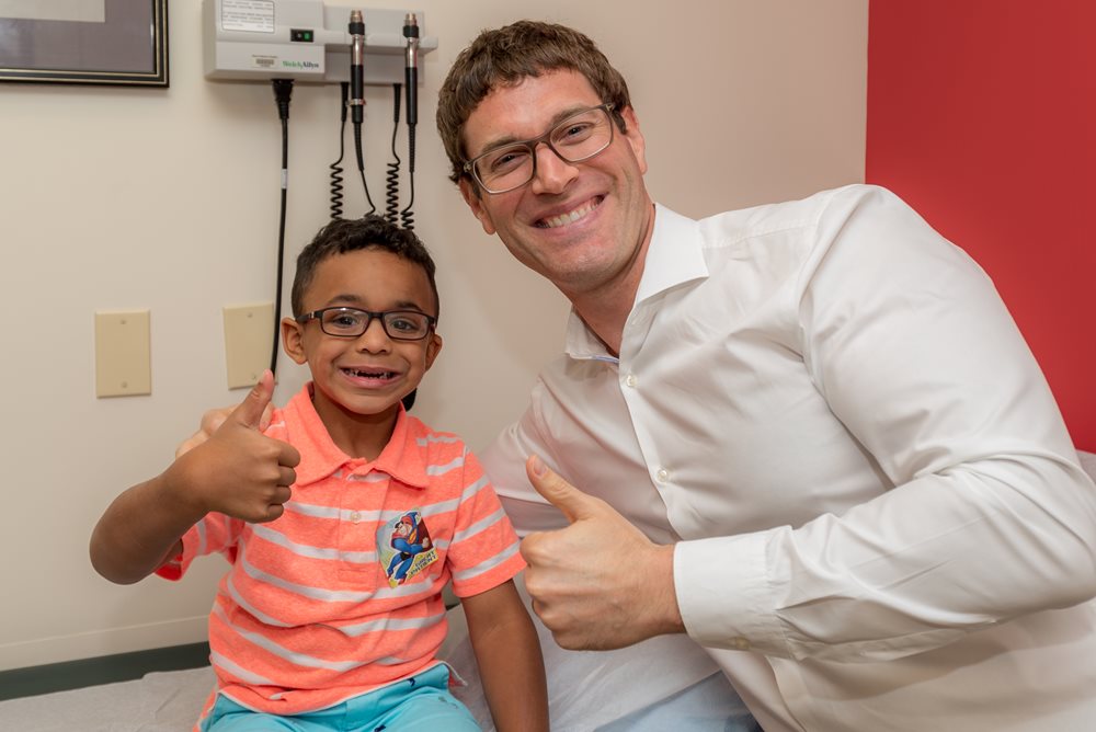 Dr. Sanders and boy give thumbs up.
