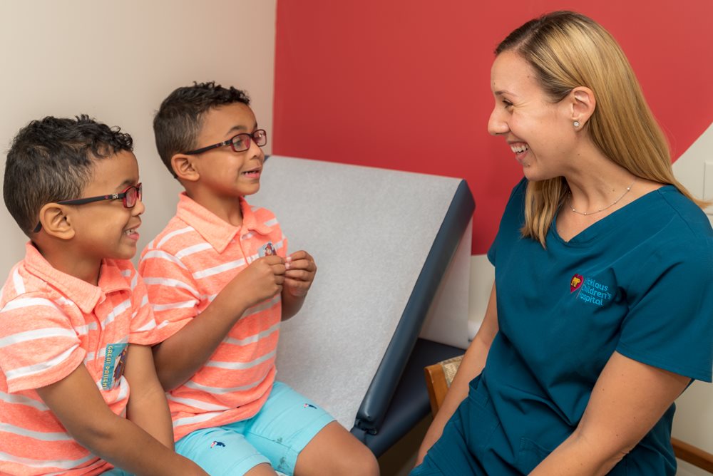 twin brothers with BWS talking with speech therapist.