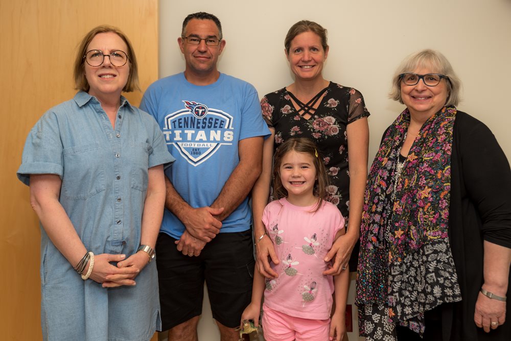 daughter with extended family at the clinic.