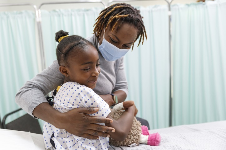 Mother comforting her daughter before a procedure.