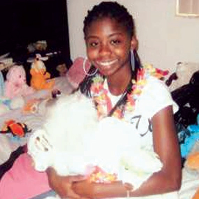 Bria smiling and holding a stuffed animal