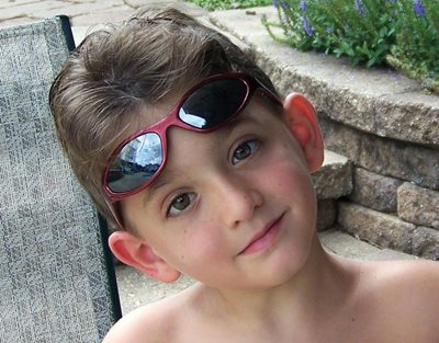 Marcos posing for the camera with a pair of sunglasses on his forehead. 