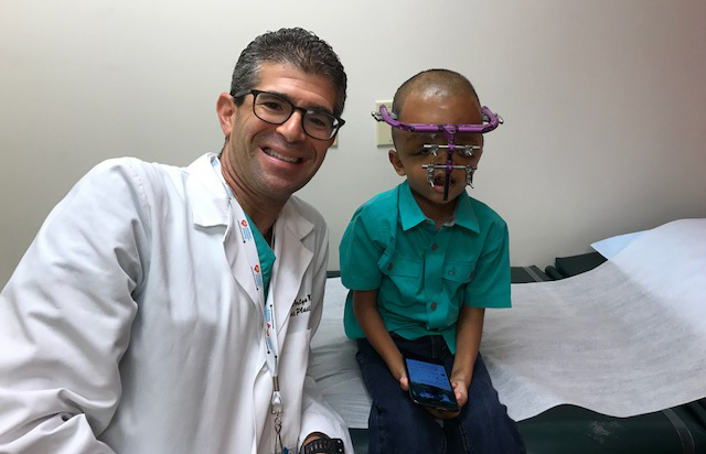 Mesut with Dr. Perlyn in an exam room after his surgery. 