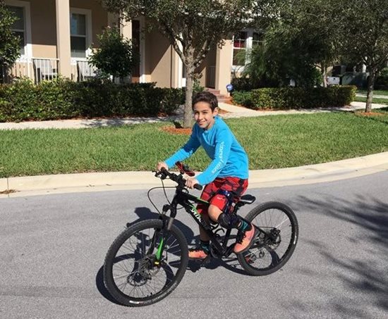 Ryan riding a bike on the street. 