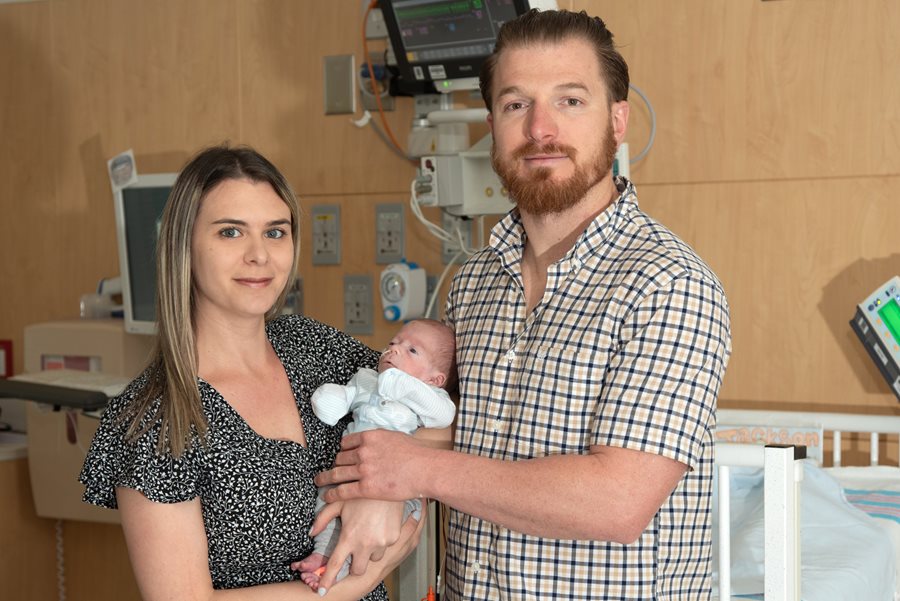 Mom and dad holding newborn Jackson at the hospital.