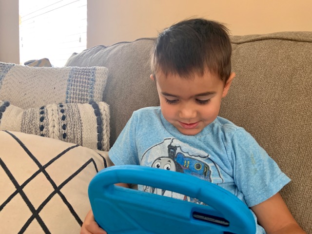 Julian playing with a tablet.