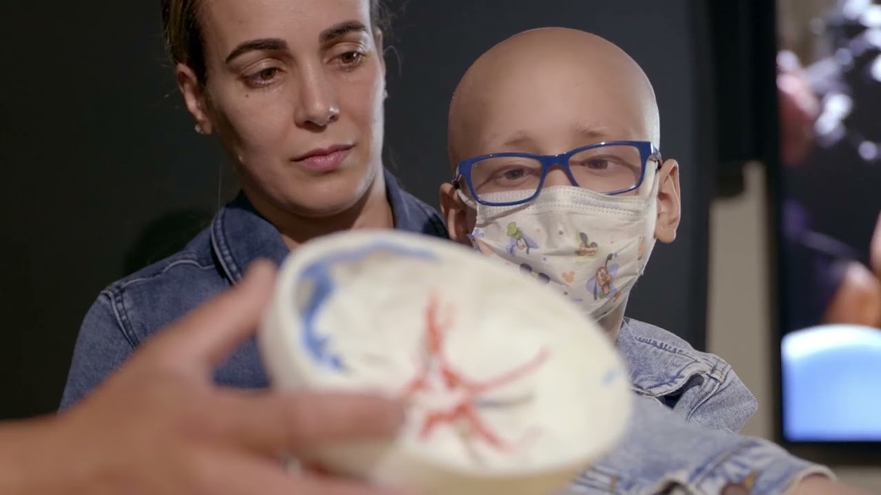 roy and mom looking at 3d printed skull