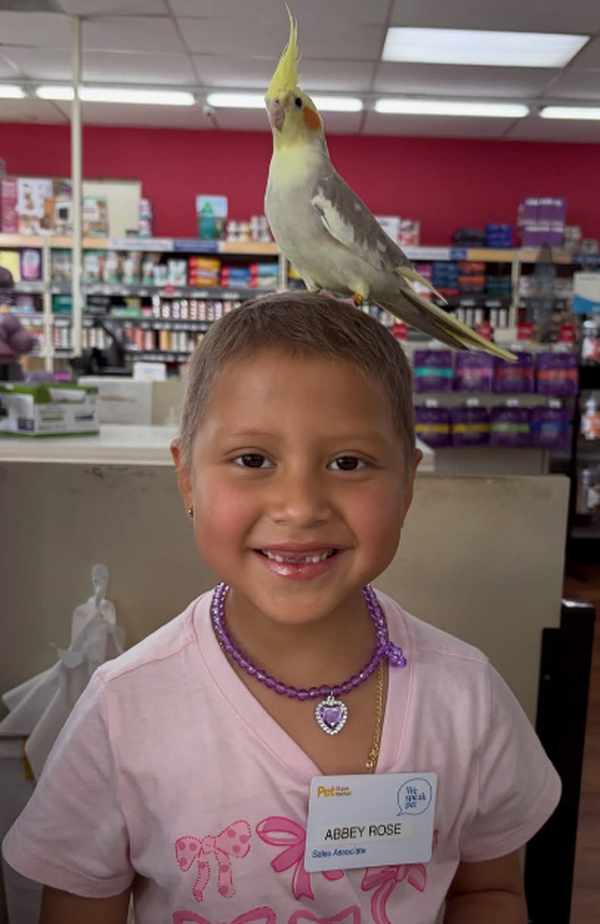 Abbey with a parrot on her head