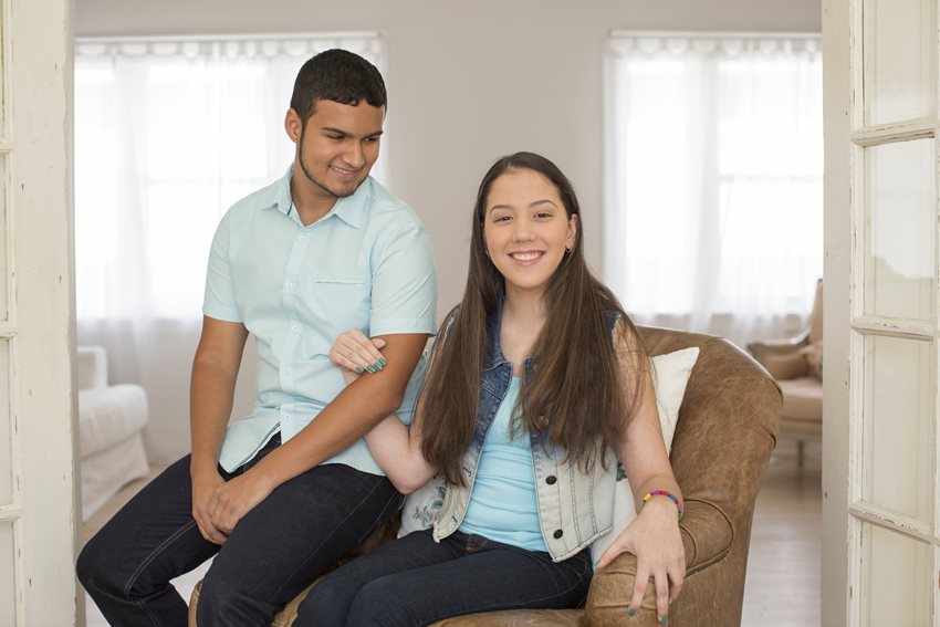 Astry sitting in a love seat.