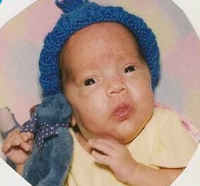 Baby Destiny wearing a blue baby cap.