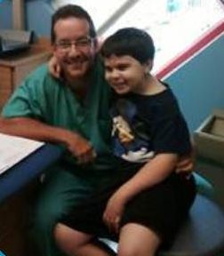 Keith next to his surgeon at Nicklaus Children's Hospital