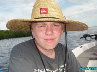 Ryan on a boat wearing a hat