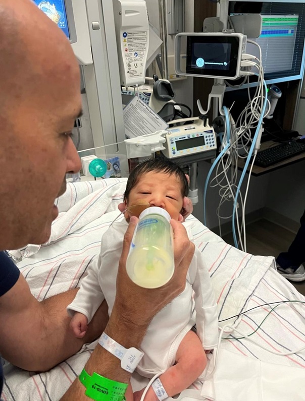 Sebastian being bottle fed by his dad