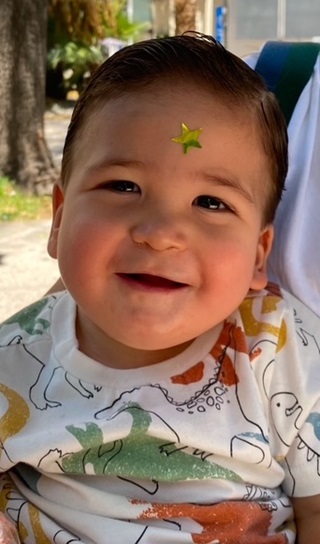 Sebastian smiling with star sticker on forehead