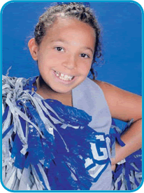 Alexis in her cheerleader uniform smiling for the camera