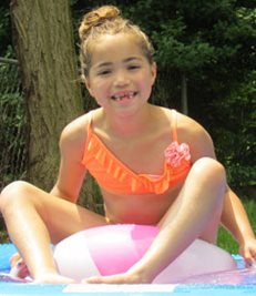 Amelia playing in a pool 