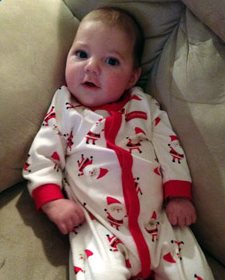 Baby Colton wearing a Christmas themed onesie 