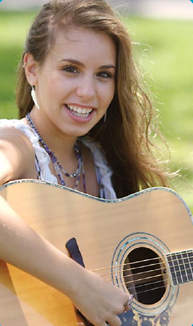 Eliza playing an acoustic guitar