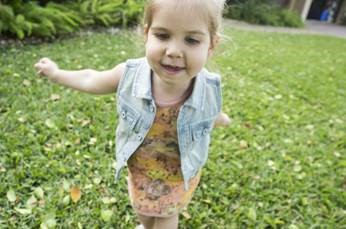 Emily running on green grass.