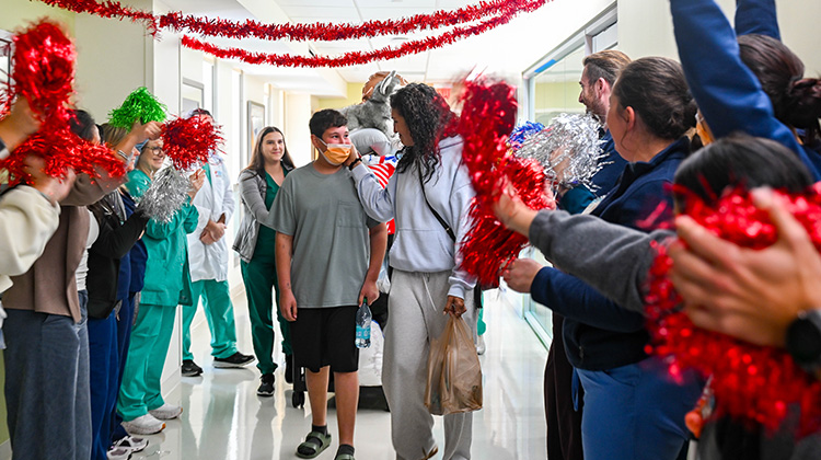 the medical team celebrates greyson as he is discharged from the hospital.