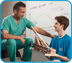 Jason posing in front of a white board with his surgeon Dr. Steven Stylianos