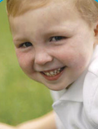 Matthew smiling at the camera while wearing a white polo shirt.