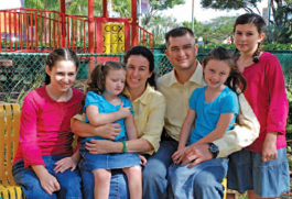 Natalie surrounded by her sisters and parents