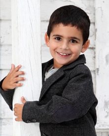 Nolan with arms wrapped around a porch pillar