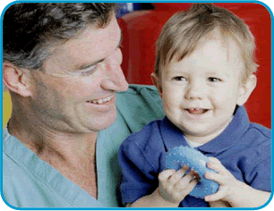 Parker smiling while being carried by his surgeon Dr. Burke.