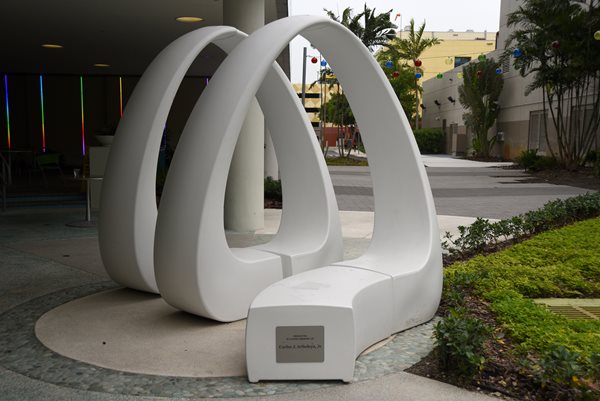 White sculpture with two loops.