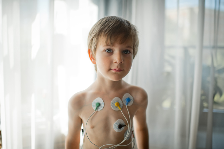 boy with electrodes on his chest.