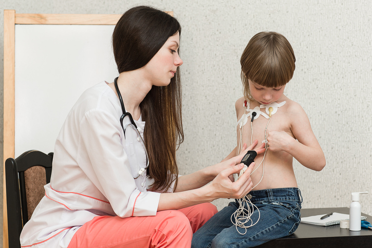 tech removing electrodes from child.