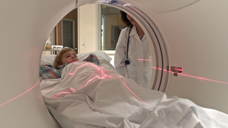 boy on MRI tray during a scan.