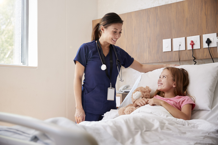 nurse by the hospital bedside of a girl.