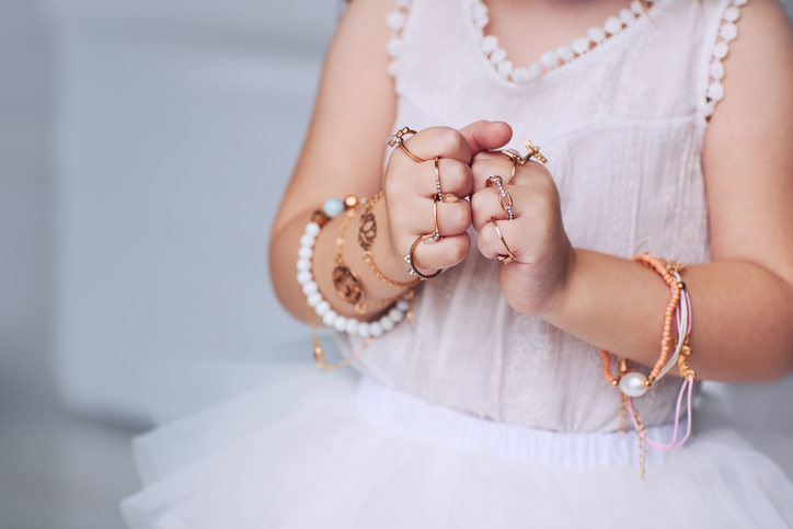girl wearing rings and bracelets.
