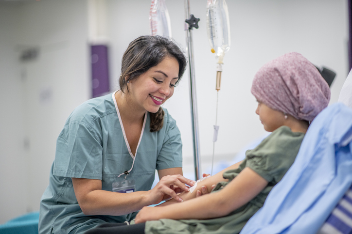 Nurse placing IV on child's arm.