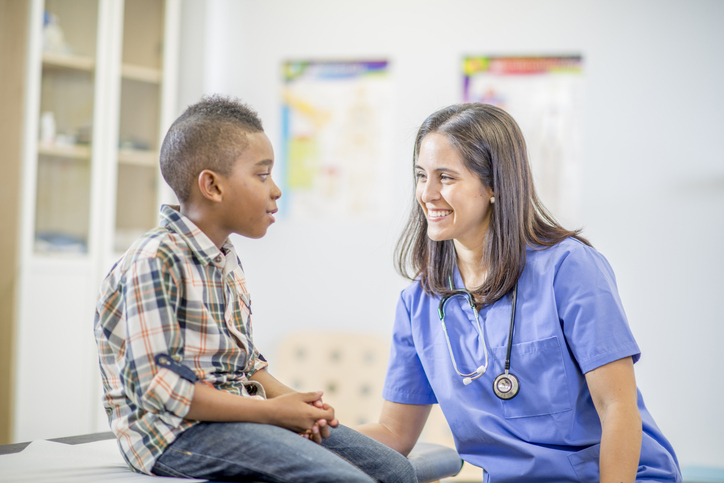 friendly nurse talking to a boy.