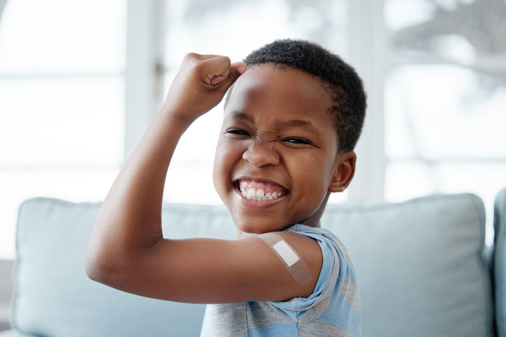 boy proudly displaying his bandaged arm.