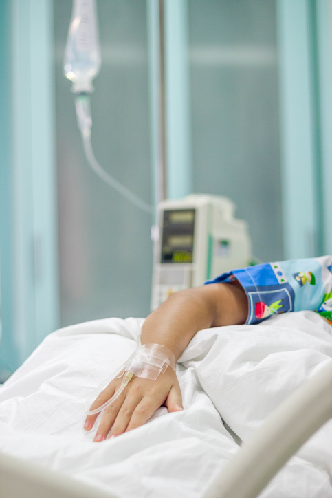 boy's arm taped up with an IV.