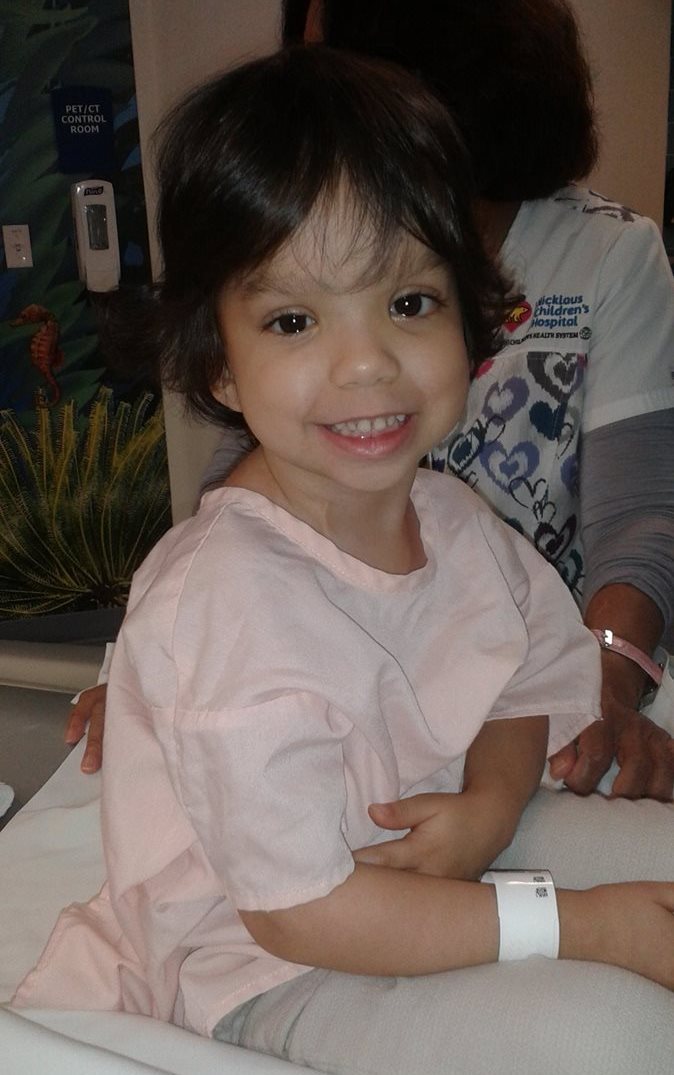 Gia sitting up in her hospital bed.