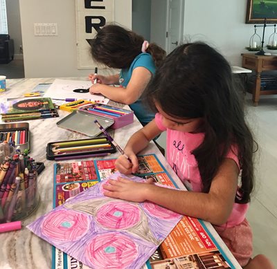 grace and gianna working on a coloring project