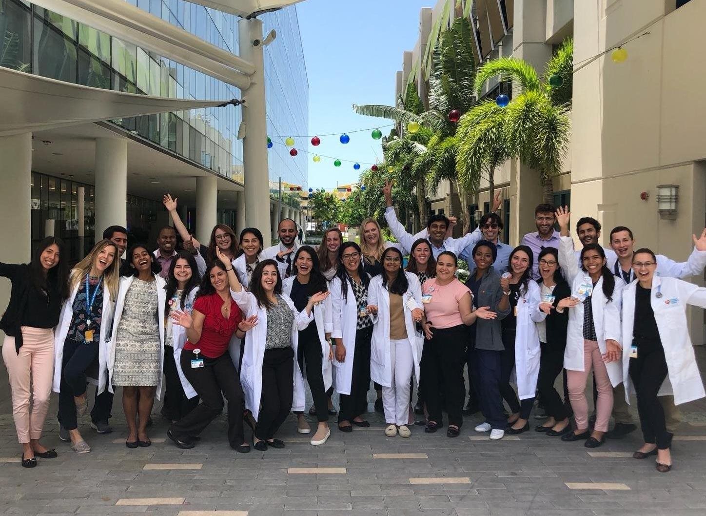 group photo of staff celebrating in hospital courtyard