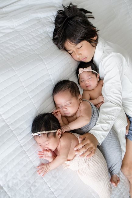 Ayan hugging the triplets.