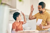 Dad high-fiving son